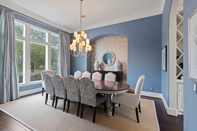 2 N Badger Lodge Cir, The Woodlands, TX 77389 - dining area featuring a chandelier, healthy amount of natural light, crown molding, and dark wood-style floors