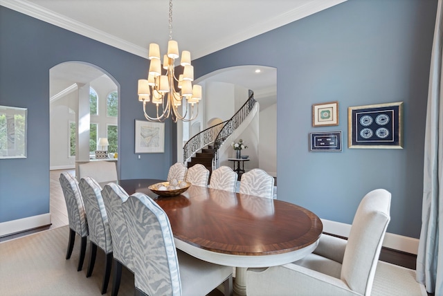 2 N Badger Lodge Cir, The Woodlands, TX 77389 - dining area with arched walkways, a chandelier, stairway, and crown molding
