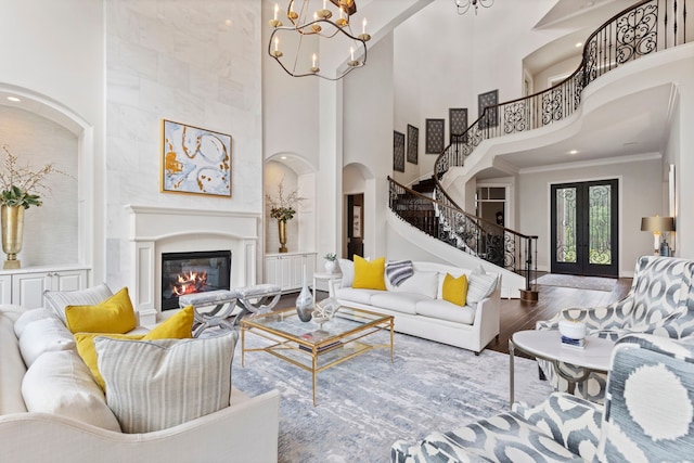 2 N Badger Lodge Cir, The Woodlands, TX 77389 - living area with a high ceiling, stairs, wood finished floors, crown molding, and a chandelier