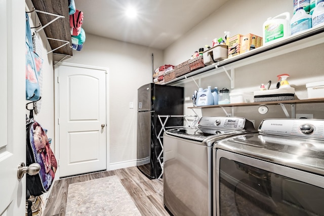 18202 Octavio Frias Trl, Houston, TX 77044 - laundry room with independent washer and dryer and light wood-type flooring