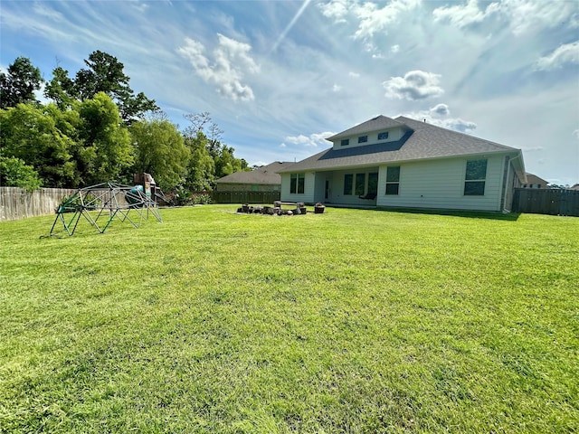 18202 Octavio Frias Trl, Houston, TX 77044 - rear view of property with a fenced backyard and a playground