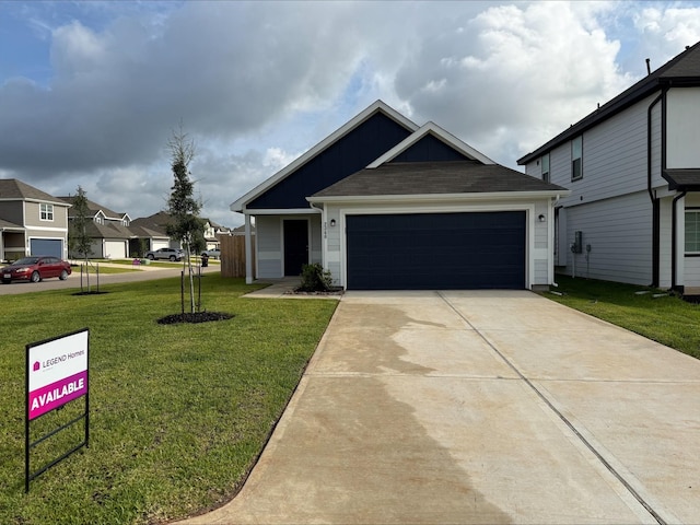 2360 Mooneye Ct, Conroe, TX 77384 - view of front of property with a front lawn, a garage, concrete driveway, and a residential view