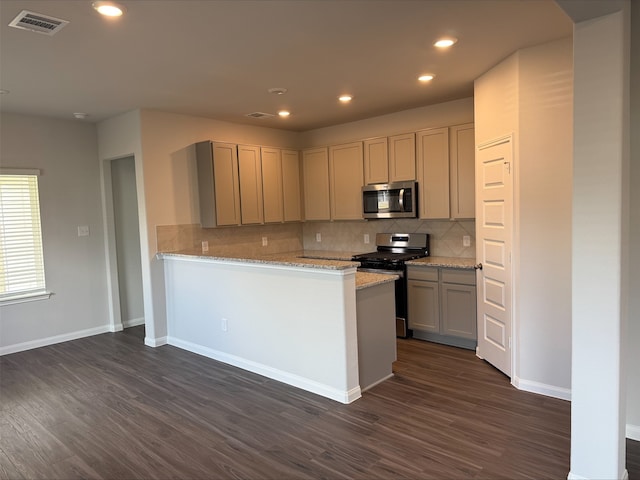 2360 Mooneye Ct, Conroe, TX 77384 - kitchen featuring appliances with stainless steel finishes, dark wood-style flooring, backsplash, light stone counters, and recessed lighting