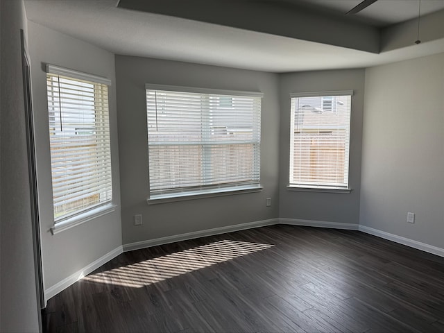 2360 Mooneye Ct, Conroe, TX 77384 - empty room featuring dark wood-style flooring, healthy amount of natural light, and a ceiling fan