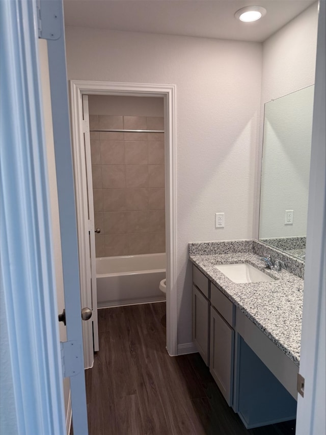 2360 Mooneye Ct, Conroe, TX 77384 - bathroom featuring vanity, wood finished floors, and shower / bathtub combination