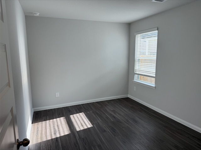 2360 Mooneye Ct, Conroe, TX 77384 - spare room with a smoke detector, plenty of natural light, and dark wood-style flooring