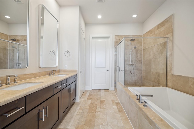 9520 London Bridge Sta, Houston, TX 77045 - full bathroom with a bath, a stall shower, double vanity, and recessed lighting
