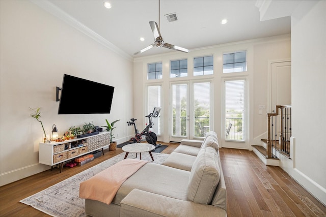 9520 London Bridge Sta, Houston, TX 77045 - living room featuring crown molding, wood finished floors, a ceiling fan, stairway, and recessed lighting