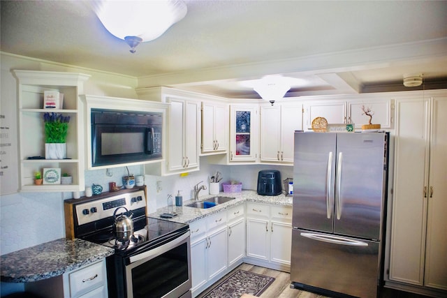 1315 N Roberson St, Conroe, TX 77301 - kitchen with stainless steel appliances, white cabinets, open shelves, light wood-style flooring, and light stone countertops