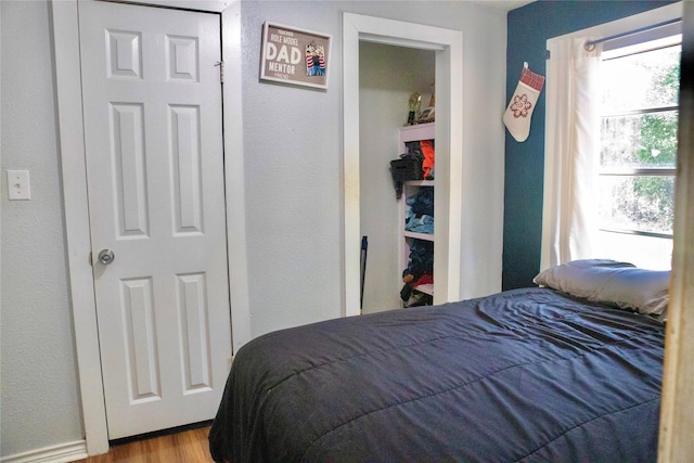 1315 N Roberson St, Conroe, TX 77301 - bedroom with wood finished floors and a textured wall