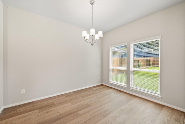426 Emerald Thicket Ln, Huffman, TX 77336 - spare room with light wood finished floors and a chandelier
