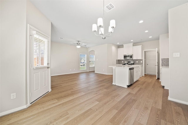 426 Emerald Thicket Ln, Huffman, TX 77336 - kitchen featuring appliances with stainless steel finishes, a ceiling fan, healthy amount of natural light, a chandelier, and recessed lighting