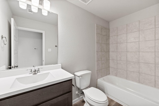 426 Emerald Thicket Ln, Huffman, TX 77336 - bathroom featuring wood finished floors, vanity, shower / bathtub combination, and a textured wall