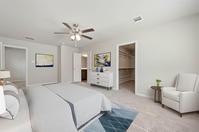 426 Emerald Thicket Ln, Huffman, TX 77336 - bedroom with light colored carpet, a walk in closet, ceiling fan, and a closet