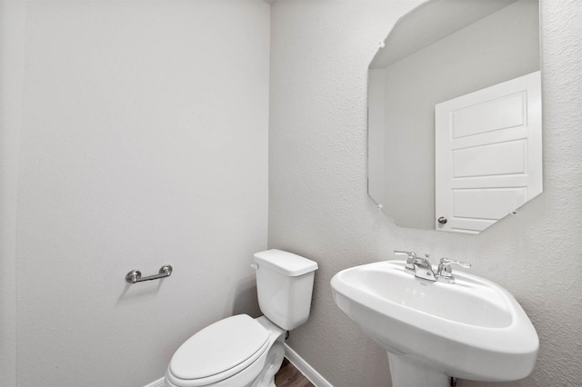 426 Emerald Thicket Ln, Huffman, TX 77336 - half bathroom featuring a sink and wood finished floors