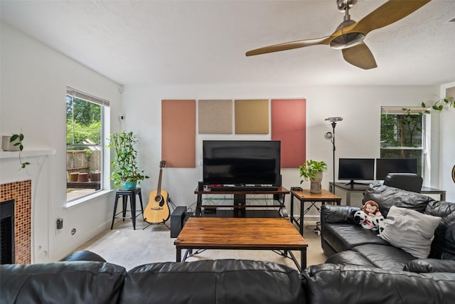 151 Anise Tree Pl, The Woodlands, TX 77382 - living area featuring ceiling fan and a tile fireplace