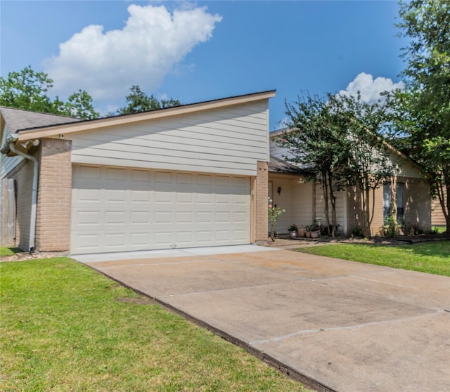 16841 Aprilmont Dr, Sugar Land, TX 77498 - view of front of property featuring a garage, brick siding, concrete driveway, and a front yard
