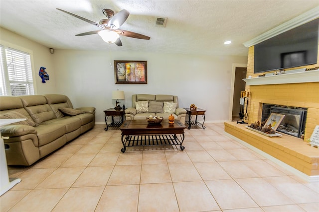16841 Aprilmont Dr, Sugar Land, TX 77498 - living area featuring a textured ceiling, a fireplace, a ceiling fan, light tile patterned flooring, and recessed lighting