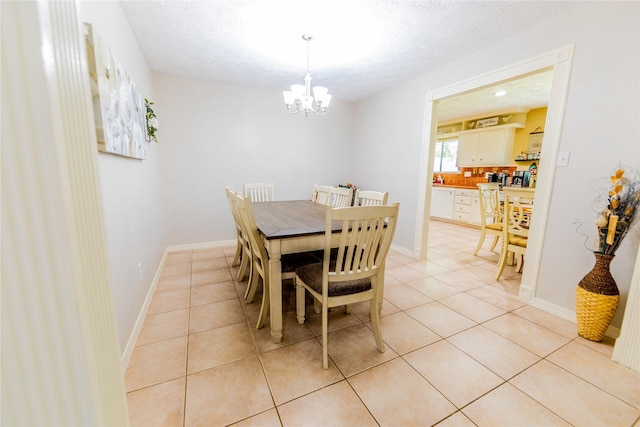 16841 Aprilmont Dr, Sugar Land, TX 77498 - dining space featuring a chandelier, light tile patterned floors, and a textured ceiling