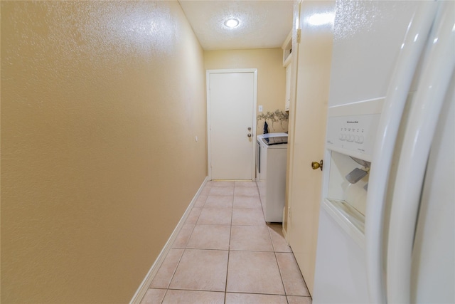 16841 Aprilmont Dr, Sugar Land, TX 77498 - hall with washer and clothes dryer, light tile patterned floors, and a textured ceiling