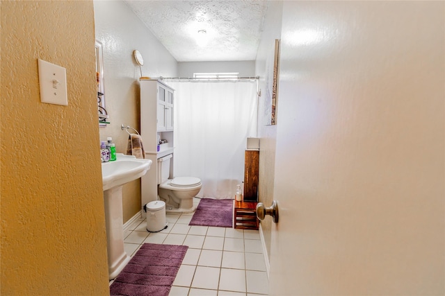 16841 Aprilmont Dr, Sugar Land, TX 77498 - bathroom with a textured ceiling, tile patterned flooring, a textured wall, and shower / tub combo with curtain