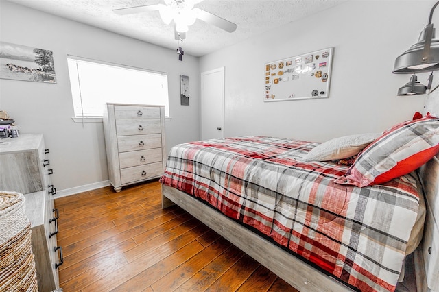 16841 Aprilmont Dr, Sugar Land, TX 77498 - bedroom featuring hardwood / wood-style floors, a textured ceiling, and a ceiling fan