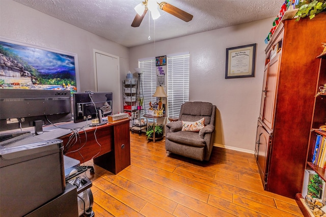 16841 Aprilmont Dr, Sugar Land, TX 77498 - home office with a textured ceiling, a ceiling fan, and hardwood / wood-style floors