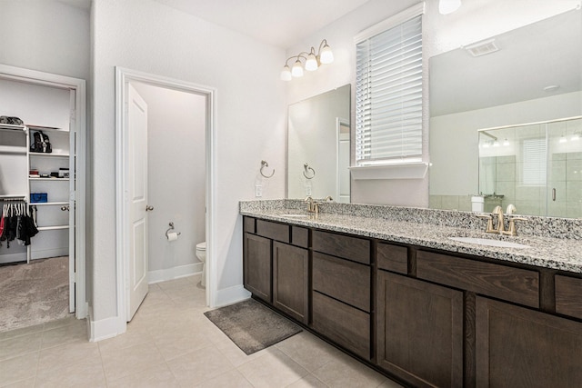 1818 Homewood Point Ln, Rosharon, TX 77583 - full bath featuring a stall shower, double vanity, a walk in closet, and tile patterned floors