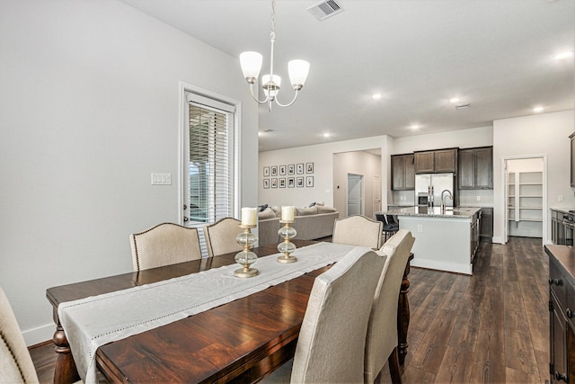 1818 Homewood Point Ln, Rosharon, TX 77583 - dining space featuring a chandelier, dark wood-style flooring, and recessed lighting