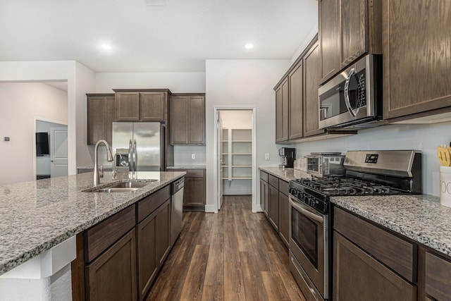 1818 Homewood Point Ln, Rosharon, TX 77583 - kitchen featuring appliances with stainless steel finishes, dark wood-type flooring, light stone counters, dark brown cabinets, and recessed lighting