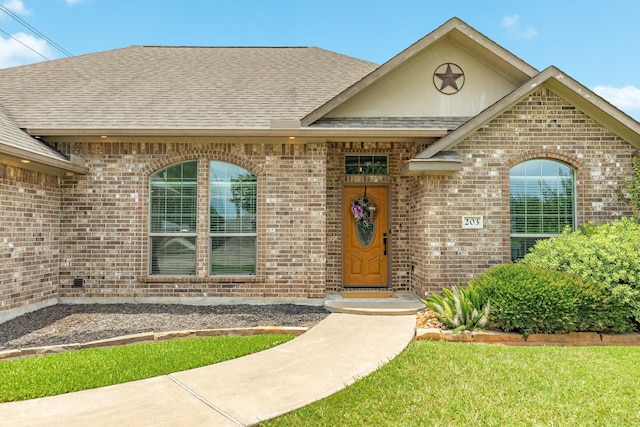 203 Poppy St, Lake Jackson, TX 77566 - view of front of home featuring brick siding and roof with shingles