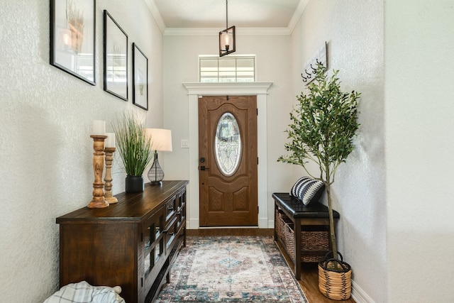203 Poppy St, Lake Jackson, TX 77566 - entryway featuring wood finished floors, a textured wall, and crown molding