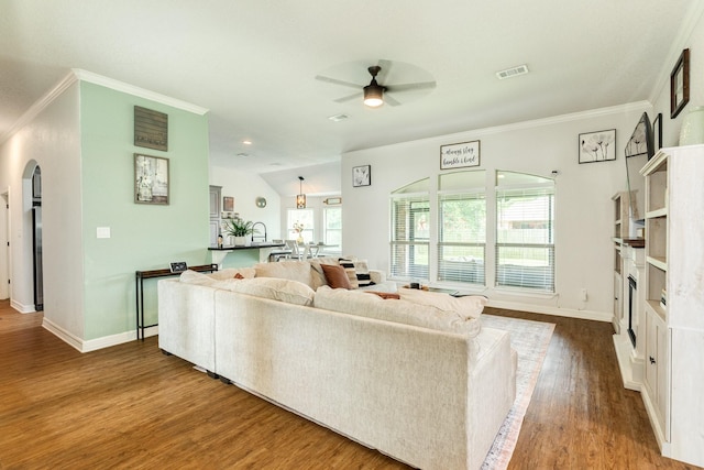 203 Poppy St, Lake Jackson, TX 77566 - living area with a ceiling fan, arched walkways, wood finished floors, and crown molding