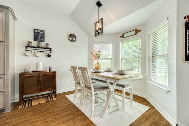 203 Poppy St, Lake Jackson, TX 77566 - dining space with healthy amount of natural light, wood finished floors, lofted ceiling, and a chandelier