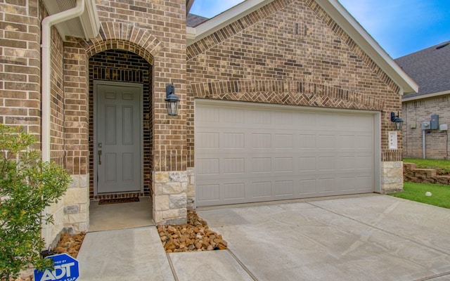 309 Pleasant Hill Way, Conroe, TX 77304 - entrance to property with brick siding, driveway, an attached garage, and stone siding