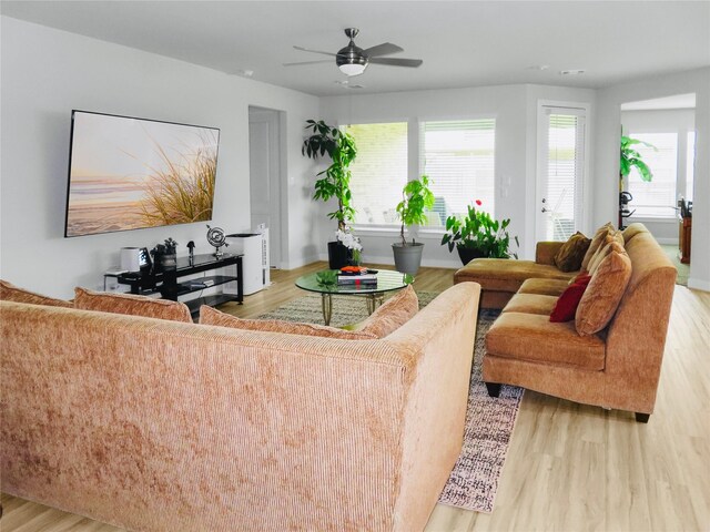 7827 Albury Mnr, Richmond, TX 77407 - living room featuring wood finished floors, healthy amount of natural light, and ceiling fan