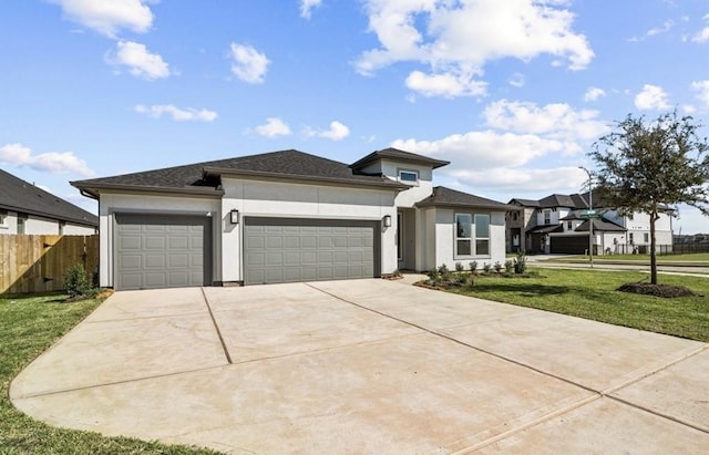 7827 Albury Mnr, Richmond, TX 77407 - prairie-style home with stucco siding, a garage, and driveway