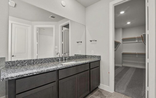 7827 Albury Mnr, Richmond, TX 77407 - bathroom with vanity, a spacious closet, tile patterned floors, and recessed lighting