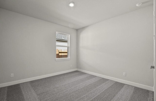 7827 Albury Mnr, Richmond, TX 77407 - unfurnished room featuring dark carpet and recessed lighting