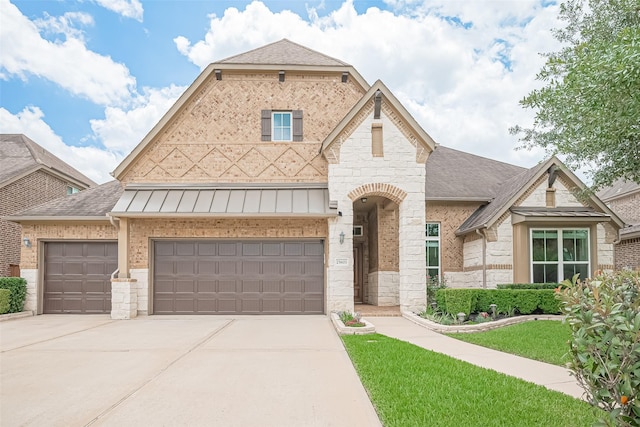 25603 Kearsley Dr, Katy, TX 77494 - french country inspired facade with driveway, stone siding, a shingled roof, a standing seam roof, and a front lawn