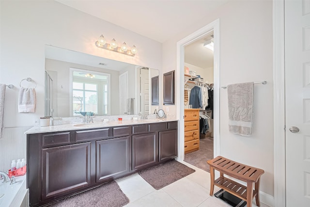 25603 Kearsley Dr, Katy, TX 77494 - bathroom with double vanity, tile patterned flooring, and a spacious closet