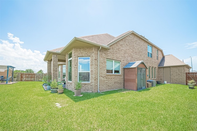 25603 Kearsley Dr, Katy, TX 77494 - back of property with a storage unit, brick siding, and a fenced backyard
