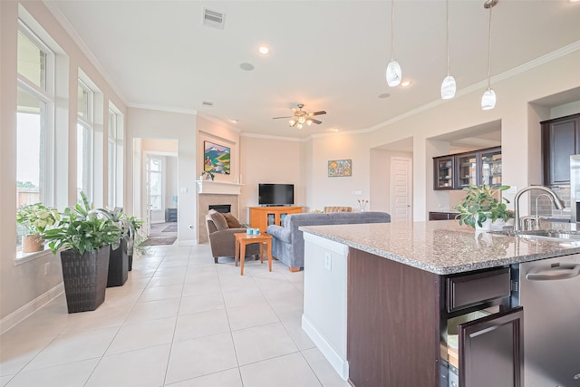 25603 Kearsley Dr, Katy, TX 77494 - kitchen featuring ceiling fan, light tile patterned flooring, crown molding, dark brown cabinetry, and stainless steel dishwasher