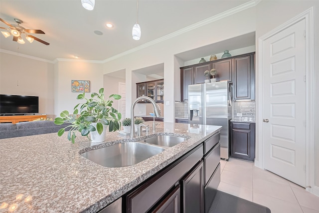 25603 Kearsley Dr, Katy, TX 77494 - kitchen with stainless steel fridge with ice dispenser, crown molding, light tile patterned floors, backsplash, and open floor plan