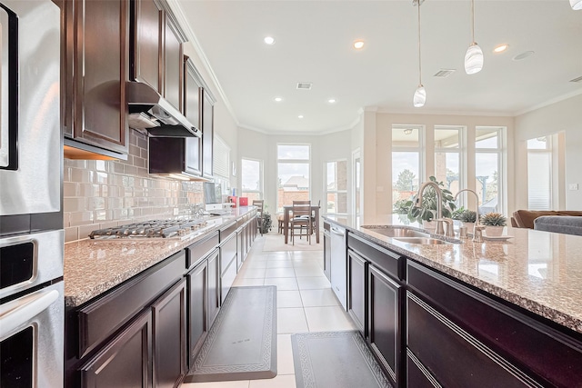 25603 Kearsley Dr, Katy, TX 77494 - kitchen featuring under cabinet range hood, stainless steel appliances, crown molding, backsplash, and dark brown cabinets