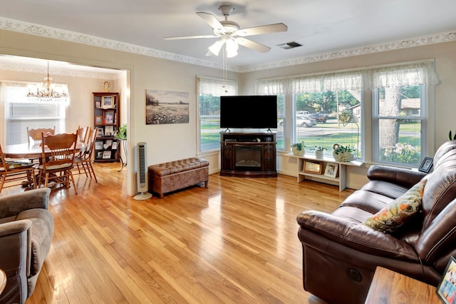 820 Meadow Ln, Wharton, TX 77488 - living area featuring a chandelier, light wood-style flooring, and a ceiling fan