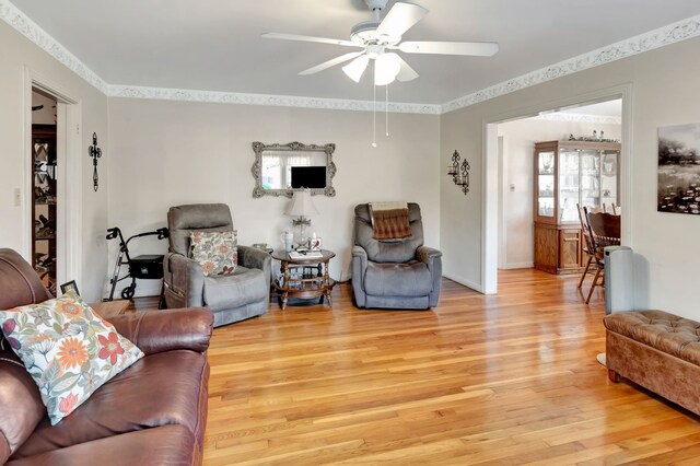 820 Meadow Ln, Wharton, TX 77488 - living room with light wood-style floors, ceiling fan, and crown molding