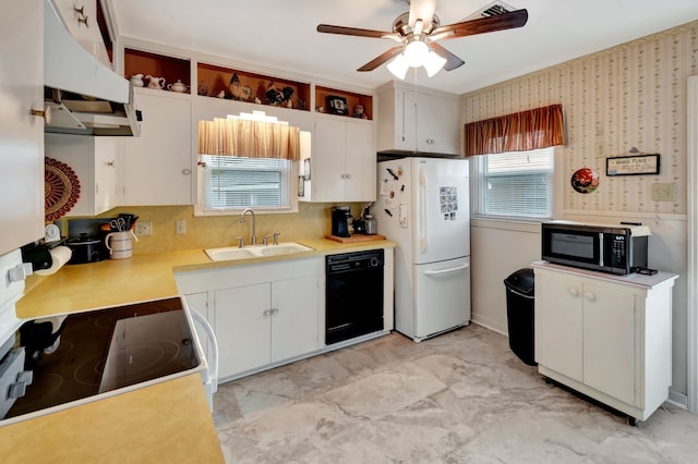 820 Meadow Ln, Wharton, TX 77488 - kitchen featuring black appliances, under cabinet range hood, ceiling fan, light countertops, and white cabinets