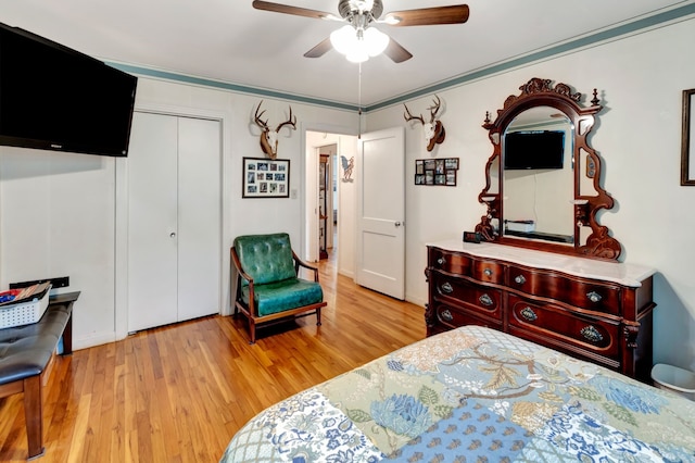 820 Meadow Ln, Wharton, TX 77488 - bedroom with wood finished floors, a closet, and a ceiling fan