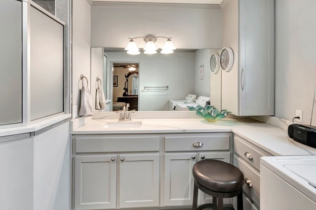 820 Meadow Ln, Wharton, TX 77488 - ensuite bathroom with separate washer and dryer, vanity, and crown molding